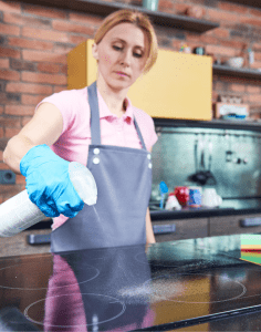 maid cleaning stove
